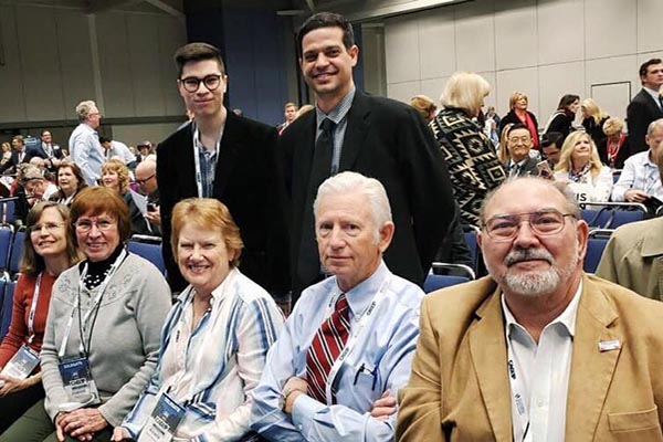 A group of people sitting in front of an audience.