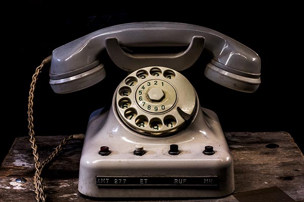 A white and black telephone sitting on top of a table.